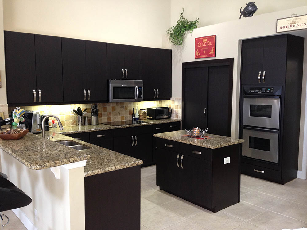 The same kitchen after refacing with dark cabinet doors