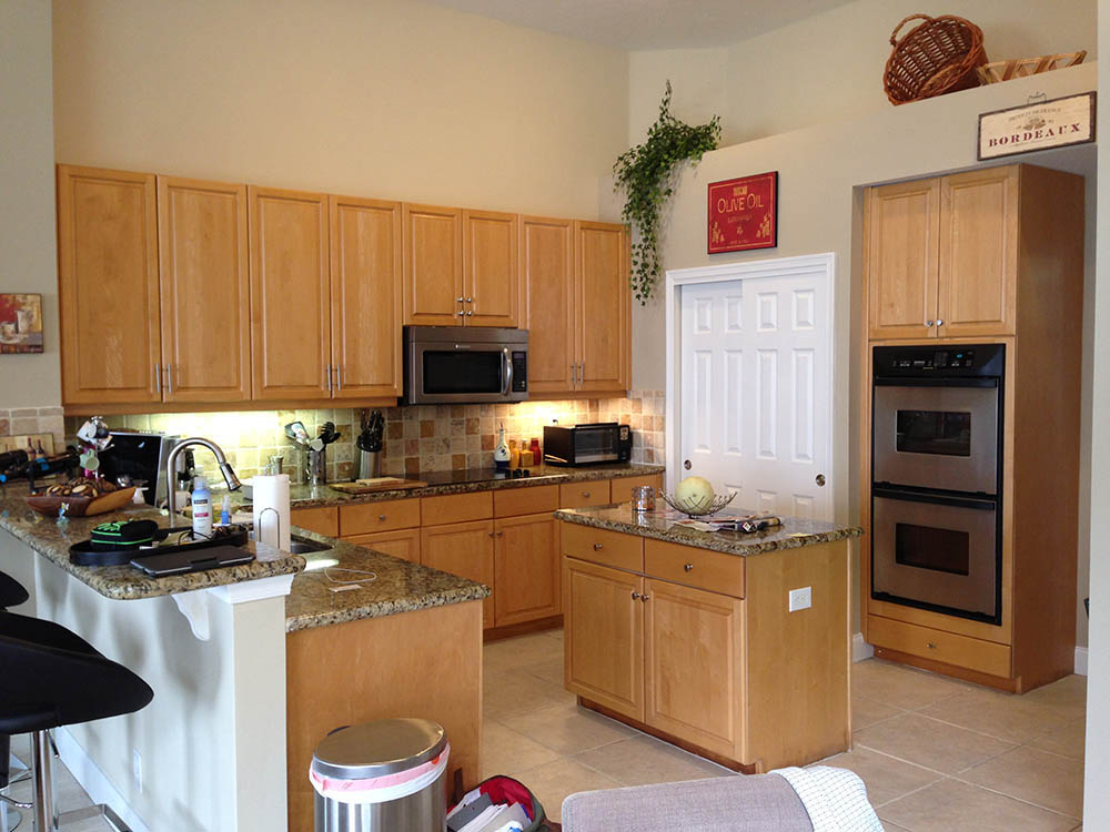 Kitchen before cabinet refacing with natural wood cabinet doors